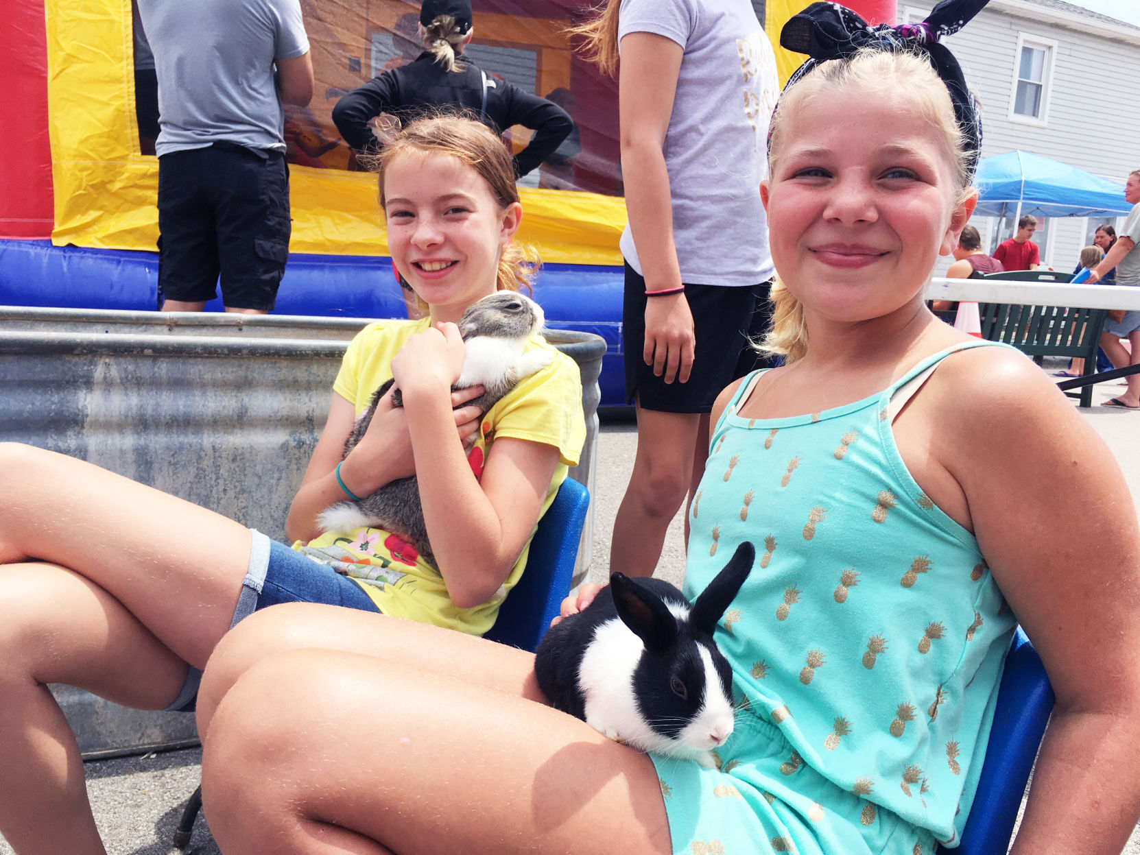 Sophie West and Finnly Pichler with rabbits at Celebrate Waterford petting zoo